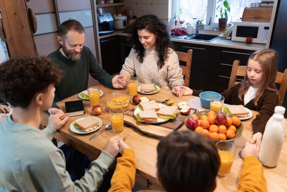 Family Sharing Their Gratitude During Breakfast As Part Of Their Morning Routine.